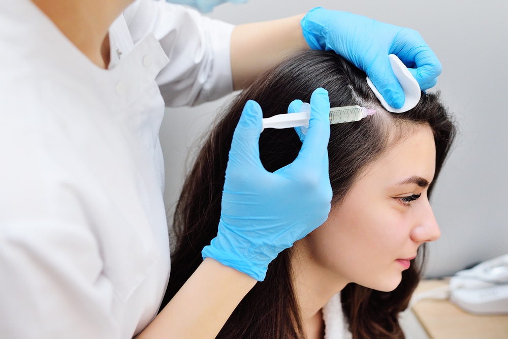 Woman getting PRP hair restoration for early hair thinning Woman getting PRP hair restoration for early hair thinning